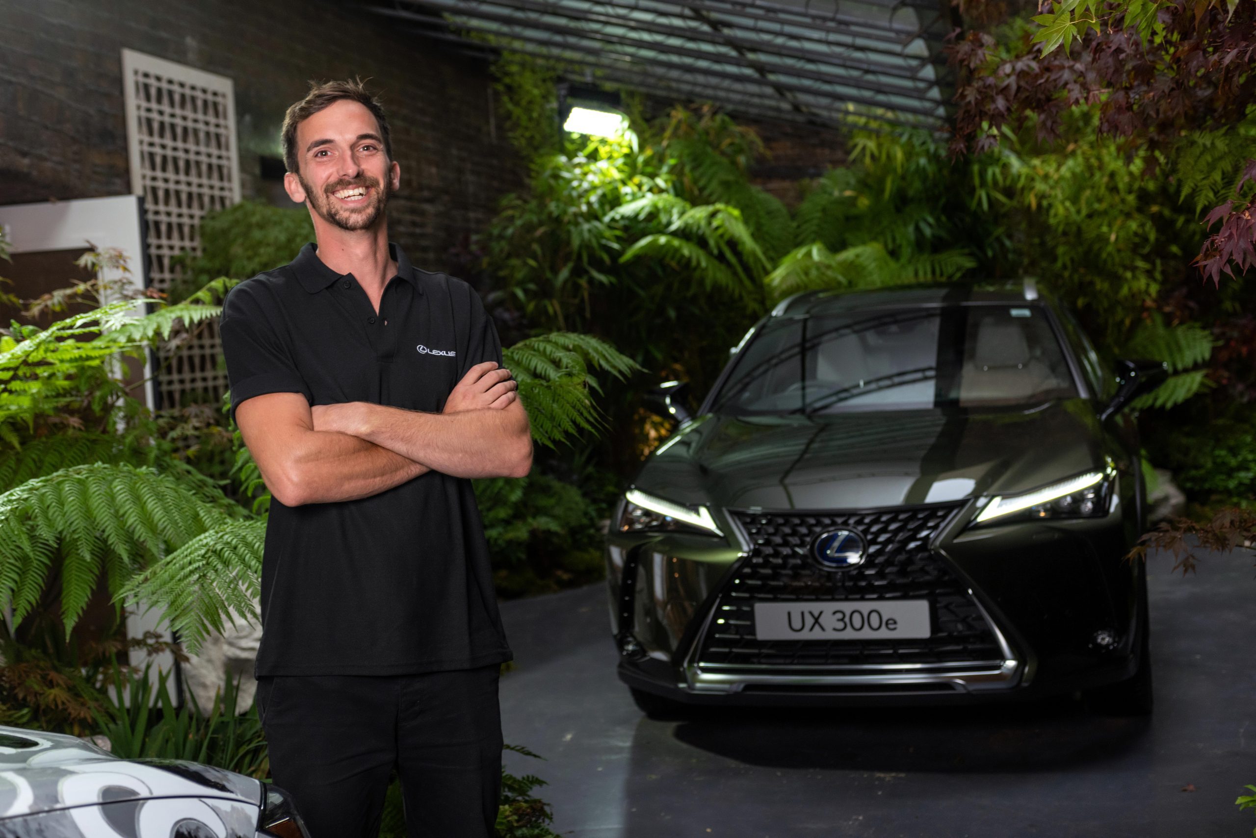 A brand ambassador poses for a photo in front of a Lexus at a brand activation event in central London for Lexus at Japan Week. The image embodies the essence of brand engagement and ambassadorship, captured by Wright Content.