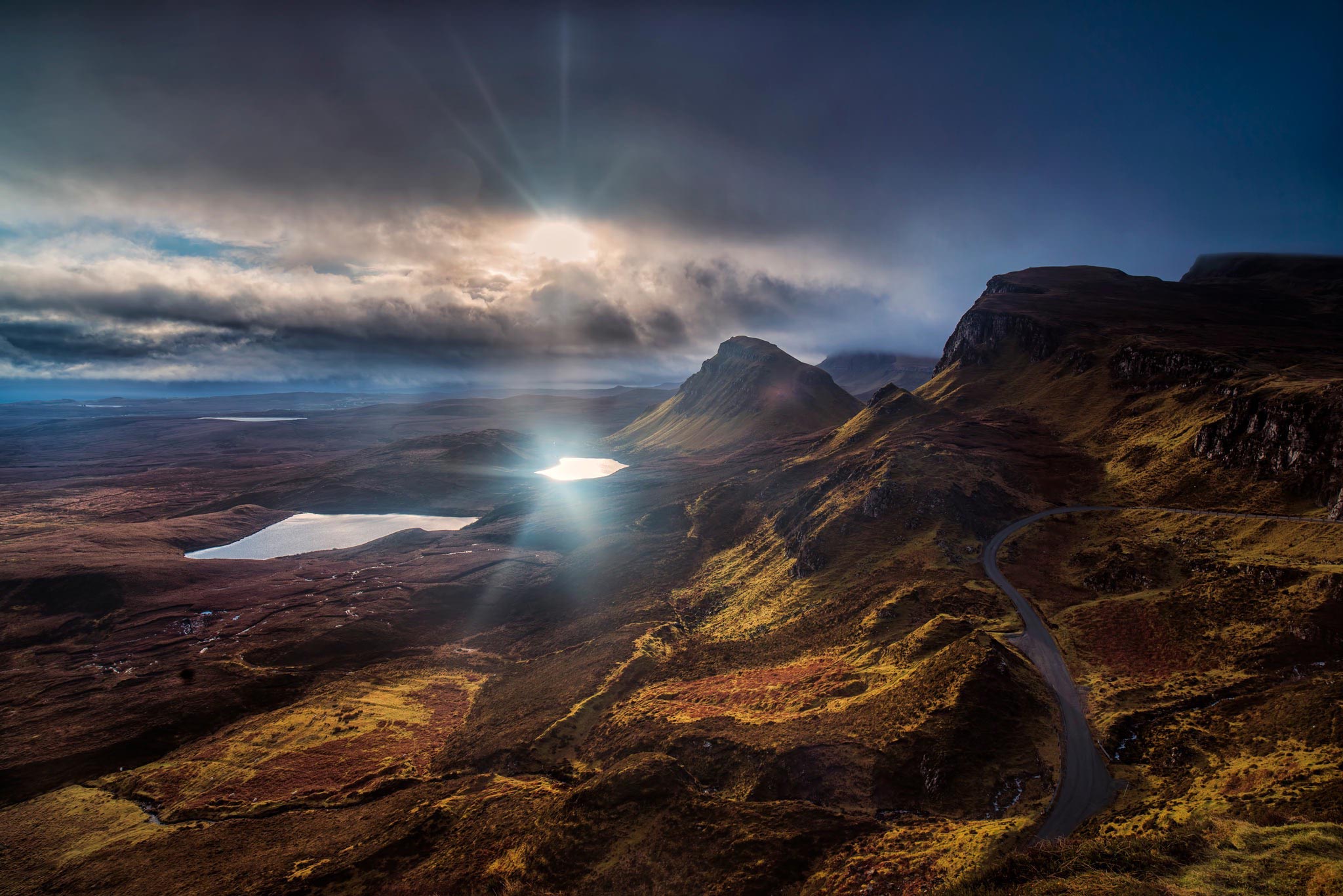 A stunning landscape photograph taken on the Isle of Skye in Scotland, featuring rugged mountains, winding roads, and tranquil lakes, illuminated by the golden rays of the sun. A stunning landscape photograph taken on the Isle of Skye in Scotland, featuring rugged mountains, winding roads, and tranquil lakes, illuminated by the golden rays of the sun.
